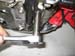 BJ Loosen 14mm bolt securing footpeg bar to engine