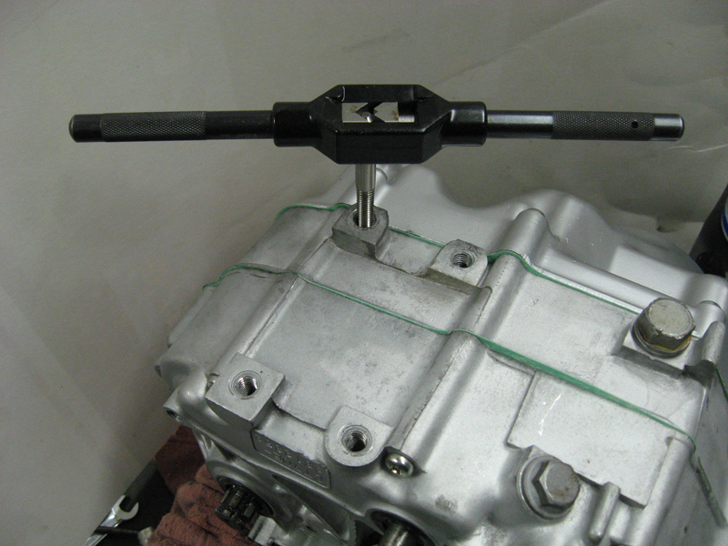 BU Shot of footpeg mount holes being chased.